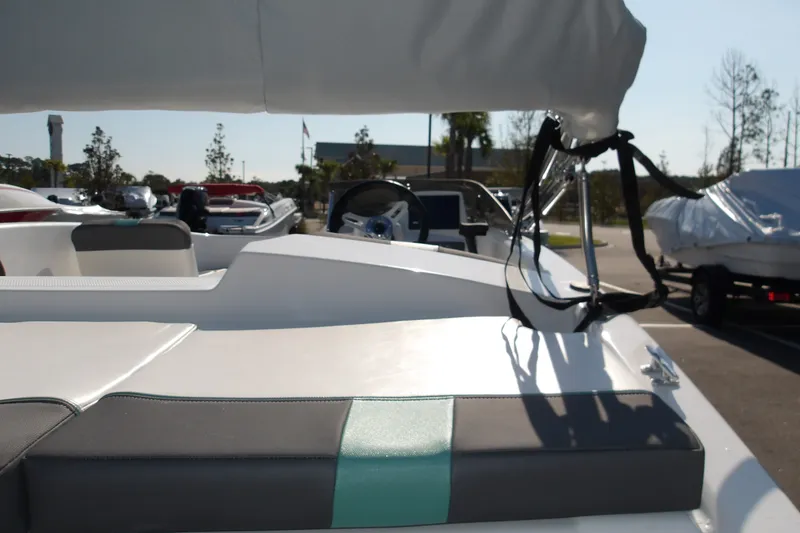 Slide: The Image of 2027 Tahoe T16 boat interior with seating and steering wheel in a sunny outdoor setting. - 9