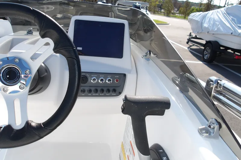 Slide: The Image of 2027 Tahoe T16 boat dashboard with steering wheel and control panel. - 11