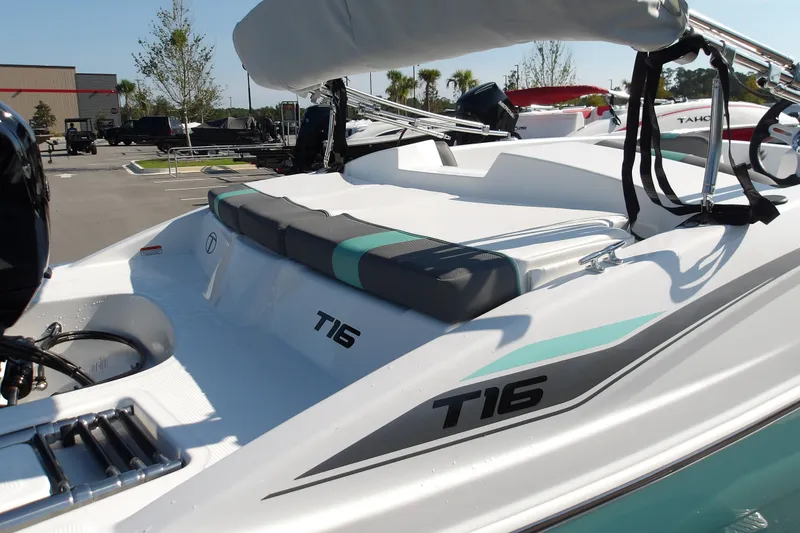 Slide: The Image of 2027 Tahoe T16 boat with sleek design and comfortable seating in a parking lot. - 10
