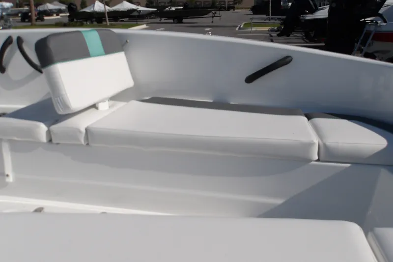 Slide: The Image of 2027 Tahoe T16 boat interior with white cushioned seating and backrest. - 12