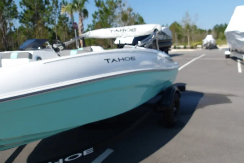 Slide: The Image of 2027 Tahoe T16 boat in a parking lot, featuring a sleek design and light blue hull. - 4