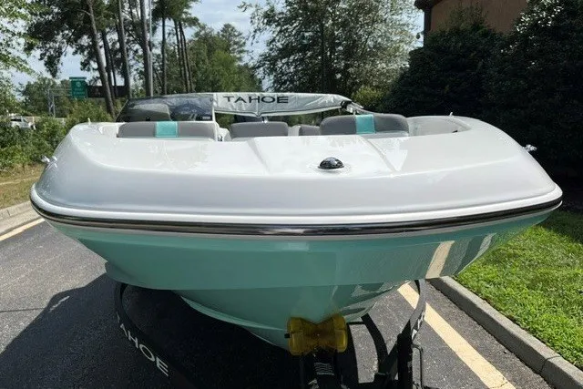 Slide: The Image of 2027 Tahoe T16 boat on trailer, front view, parked outdoors. - 2