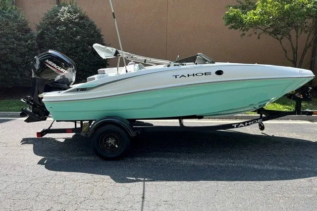 The Image of 2027 Tahoe T16 boat on trailer, mint green hull, parked outdoors. - 0
