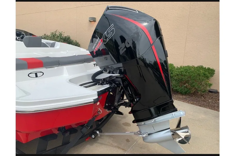 Slide: The Image of 2027 Tahoe T21 boat with sleek black and red outboard motor. - 6