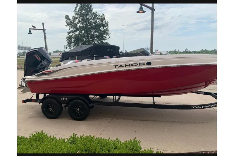 Slide: The Image of Red 2027 Tahoe T21 boat on trailer, parked outdoors. - 3