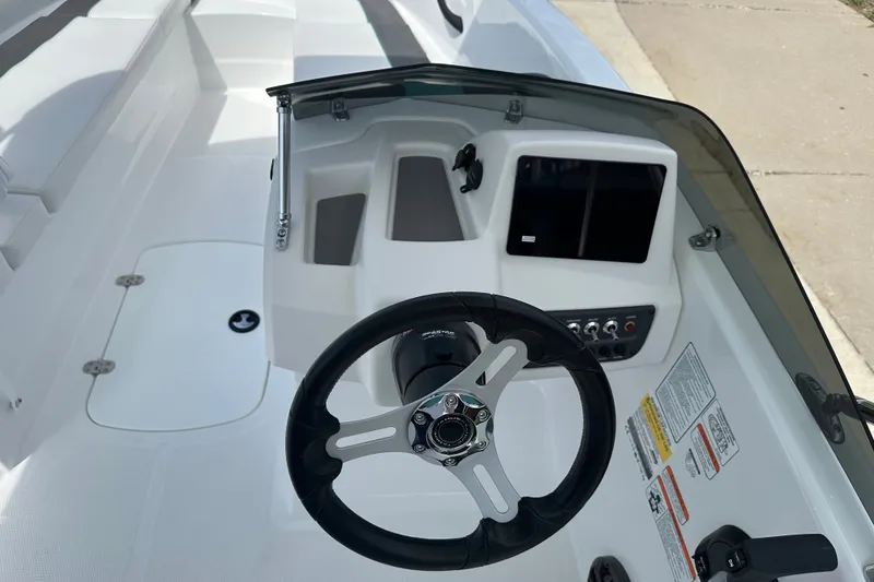 Slide: The Image of 2027 Tahoe T16 boat dashboard with steering wheel and control panel. - 15