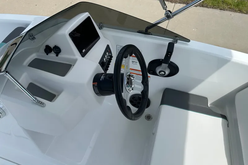 Slide: The Image of Steering console of 2027 Tahoe T16 boat with modern controls and seating. - 13