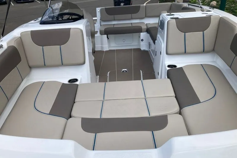 Slide: The Image of 2027 Tahoe 1950 boat interior with beige and brown cushioned seating. - 4
