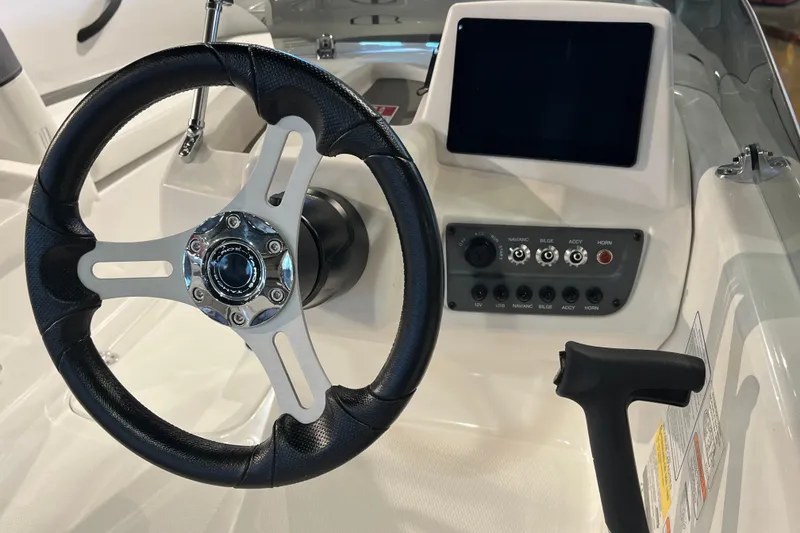 Slide: The Image of Steering wheel and dashboard of 2027 Tahoe T16 boat with control panel and display. - 10