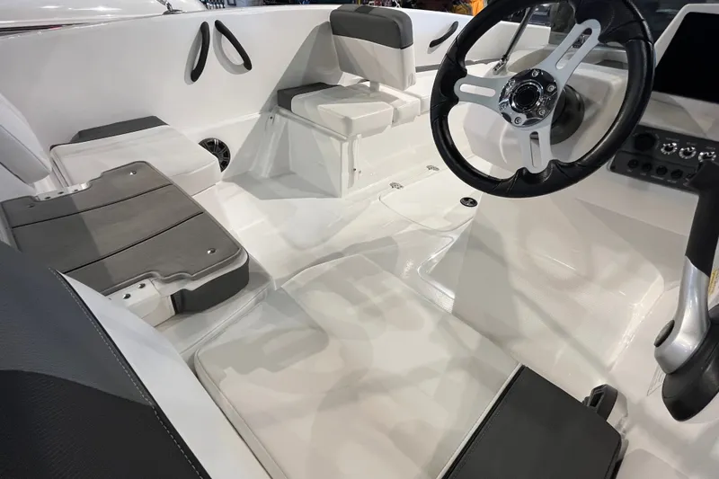 Slide: The Image of 2027 Tahoe T16 boat interior with sleek seating and modern steering wheel design. - 14