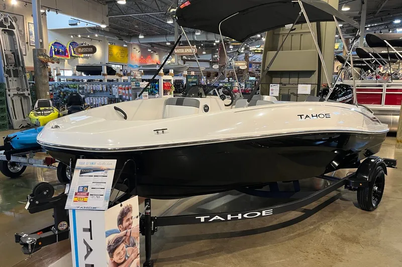 Slide: The Image of 2027 Tahoe T16 boat displayed in a showroom with promotional materials. - 1