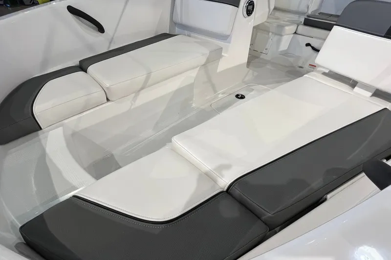 Slide: The Image of Interior seating of 2027 Tahoe T16 boat with white and gray cushions. - 16