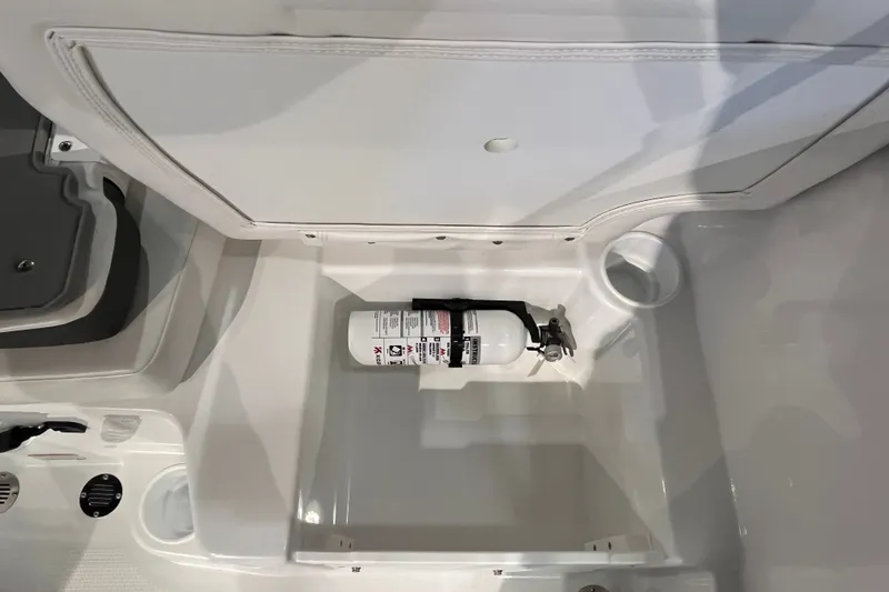 Slide: The Image of Storage compartment with fire extinguisher in 2027 Tahoe T16 boat. - 23