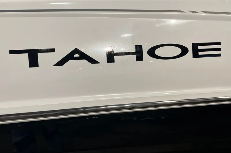 Slide: The Image of Close-up of 2027 Tahoe T16 logo on a sleek white surface. - 2