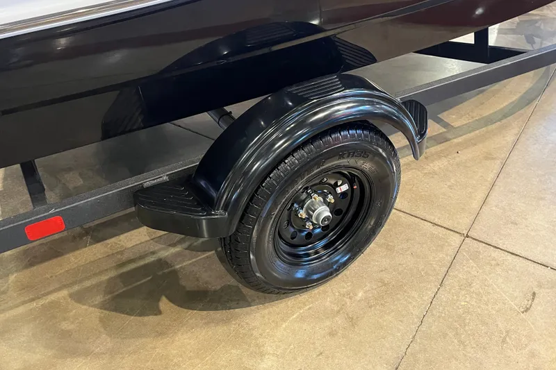 Slide: The Image of 2027 Tahoe T16 trailer wheel and fender on display indoors. - 9