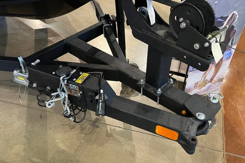 Slide: The Image of Trailer hitch assembly of a 2027 Tahoe T16, featuring safety chains and connectors. - 8
