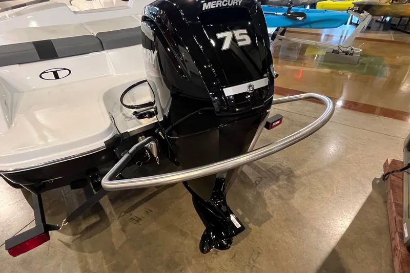 Slide: The Image of 2027 Tahoe T16 boat with Mercury 75 outboard motor in showroom. - 17