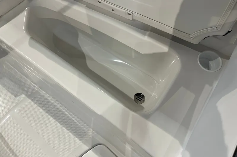 Slide: The Image of 2027 Tahoe T16 boat interior with built-in storage compartment and drain. - 31
