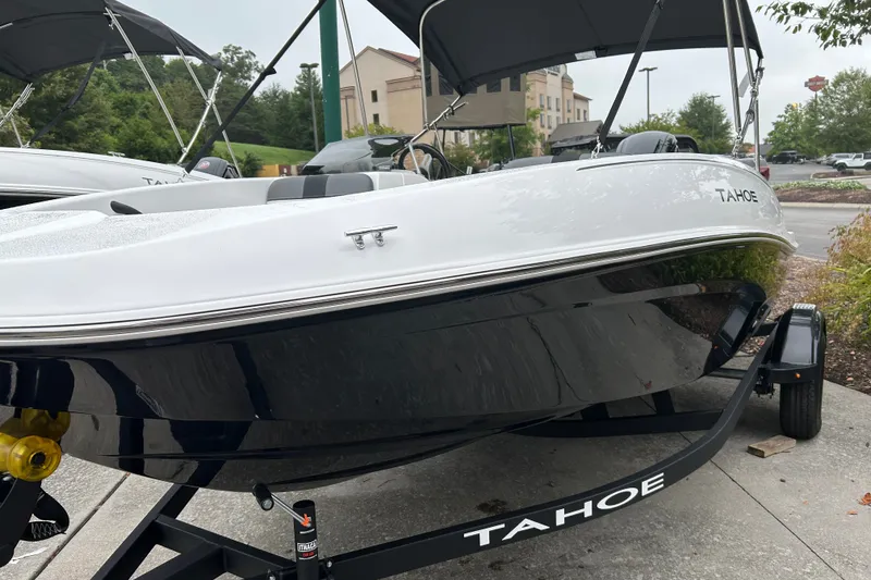 Slide: The Image of 2027 Tahoe T16 boat on trailer, sleek design, parked outdoors. - 1