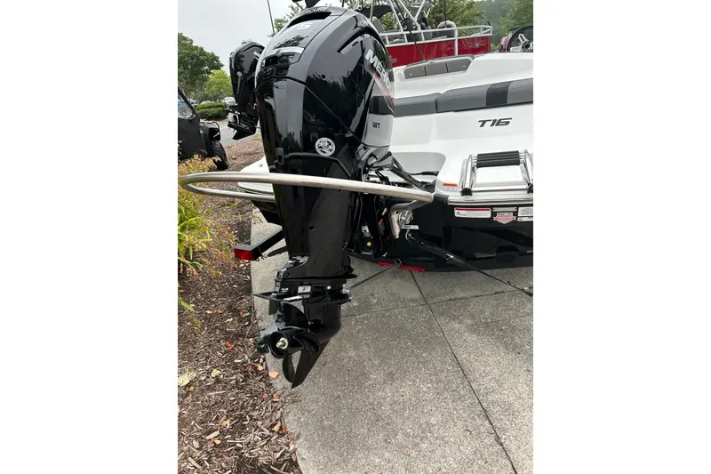 Slide: The Image of 2027 Tahoe T16 boat with Mercury outboard motor, parked on concrete surface. - 3