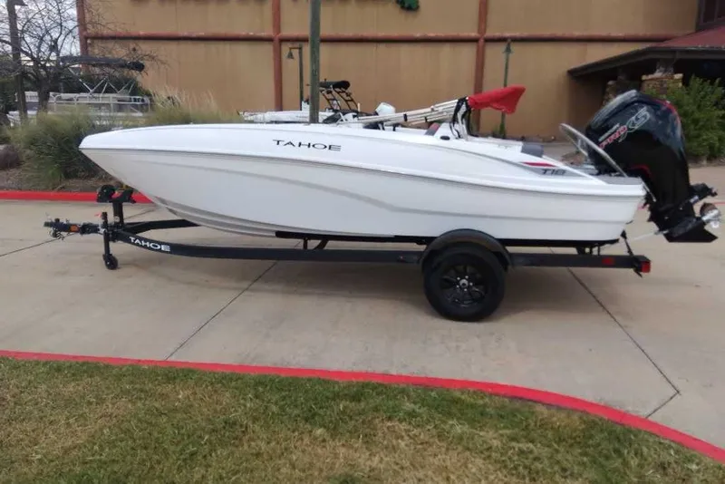 The Image of 2027 Tahoe T18 boat on trailer, parked outdoors, side view. - 0