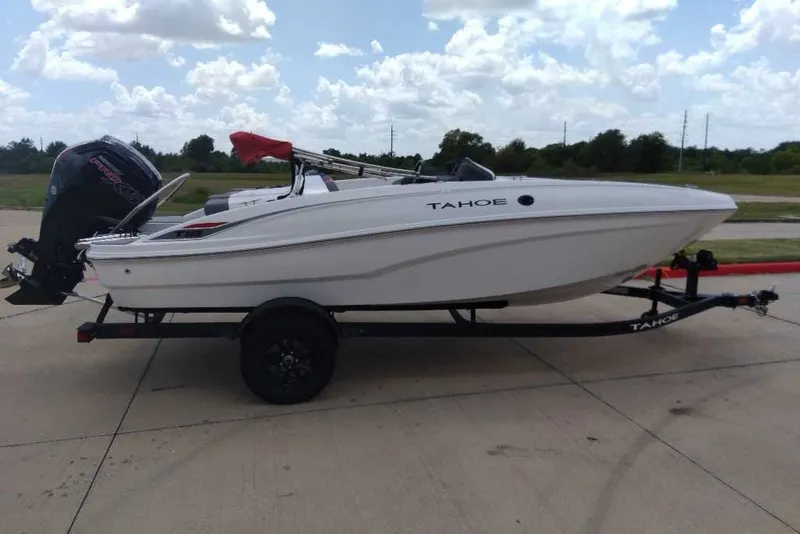 Slide: The Image of 2027 Tahoe T18 boat on trailer under cloudy sky. - 1