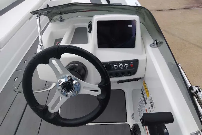 Slide: The Image of Steering console of a 2027 Tahoe T18 boat with modern controls and display. - 6