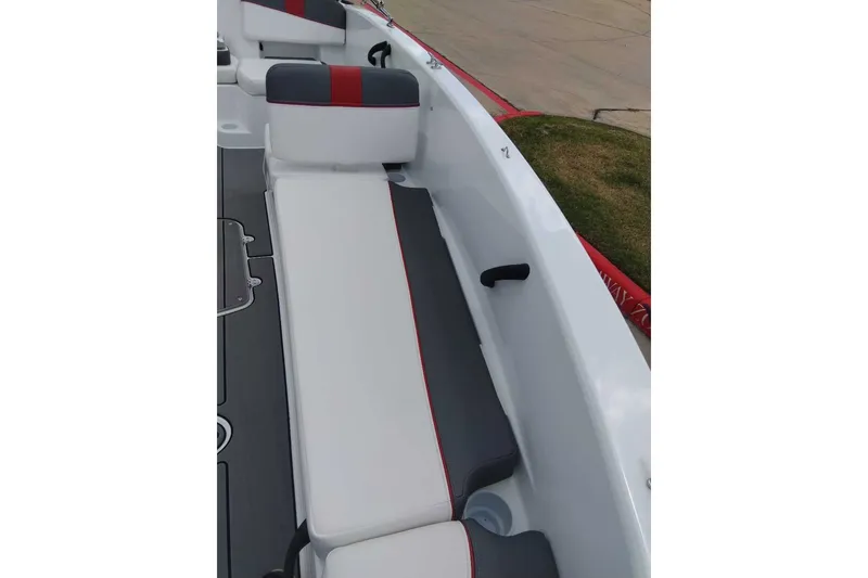 Slide: The Image of 2027 Tahoe T18 boat interior with sleek white and gray seating, red accents. - 8