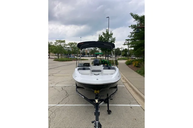 Slide: The Image of Front view of a 2027 Tahoe T16 boat on a trailer in a parking lot. - 4