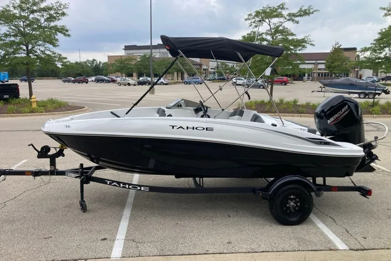 Slide: The Image of 2027 Tahoe T16 boat with canopy on trailer in parking lot. - 8