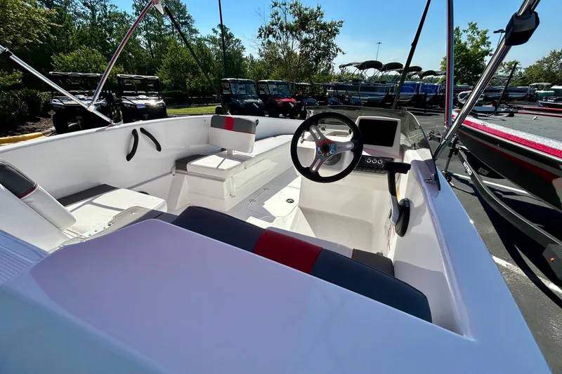 Slide: The Image of 2027 Tahoe T16 boat interior with steering wheel, seating, and control panel in a sunny outdoor setting. - 3