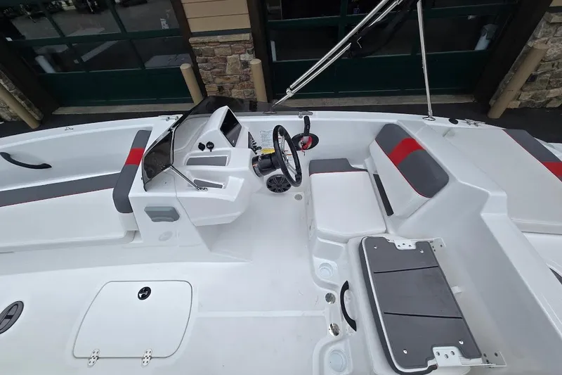 Slide: The Image of Interior view of a 2027 Tahoe T18 boat, featuring modern seating and steering console. - 6