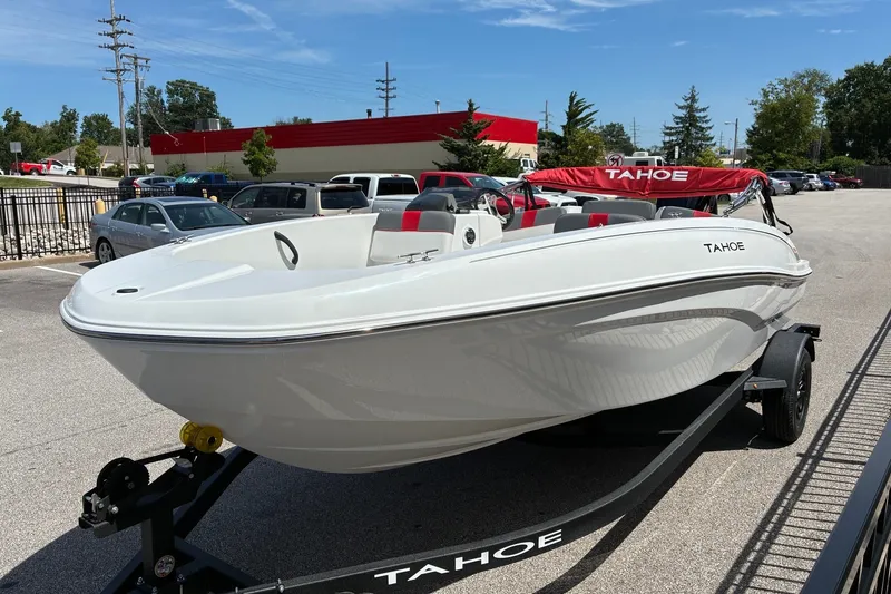 Slide: The Image of 2027 Tahoe T18 boat on trailer in parking lot, featuring sleek white design. - 5