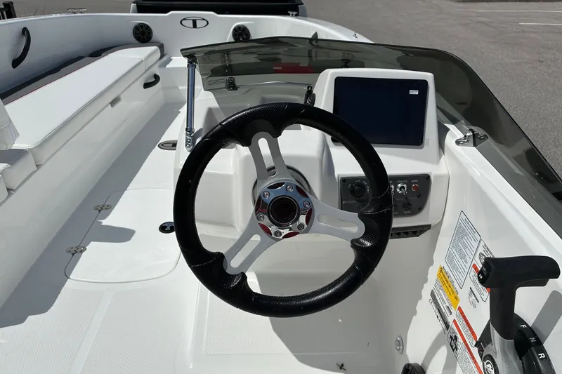 Slide: The Image of 2027 Tahoe T18 boat cockpit with steering wheel and control panel. - 10