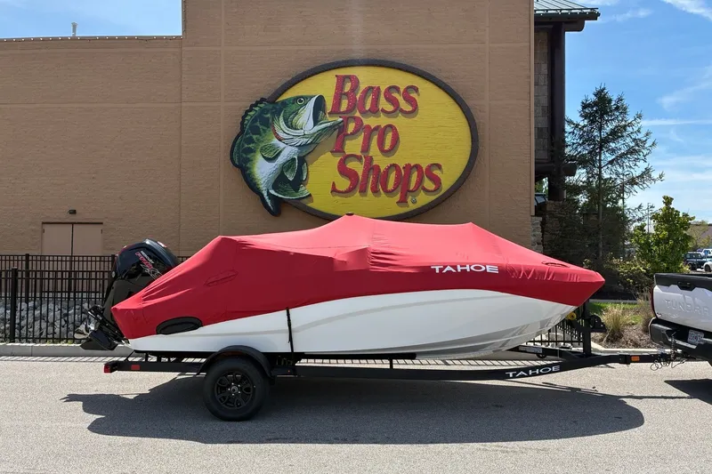 Slide: The Image of 2027 Tahoe T18 boat with red cover at Bass Pro Shops parking lot. - 11