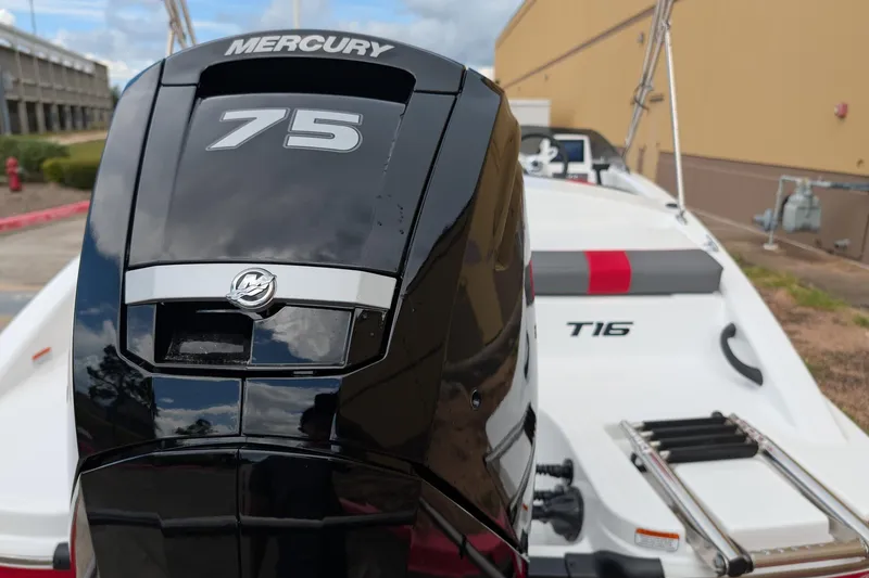 Slide: The Image of 2027 Tahoe T16 boat with Mercury 75 engine, parked outdoors. - 13