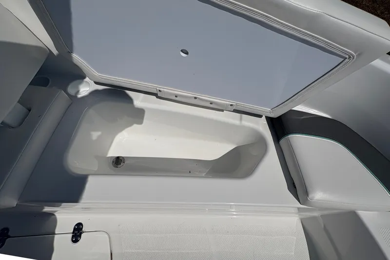 Slide: The Image of Open storage compartment in 2027 Tahoe T16 boat, showcasing interior space. - 12