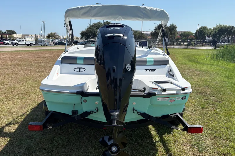 Slide: The Image of 2027 Tahoe T16 boat with outboard motor on grassy area. - 4