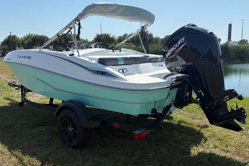 Slide: The Image of 2027 Tahoe T16 boat with Mercury engine on trailer by a lake. - 3