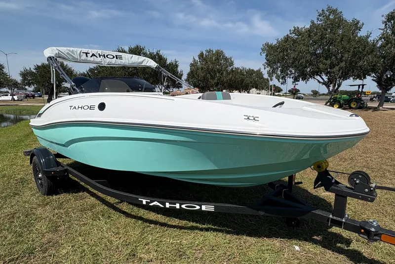 Slide: The Image of 2027 Tahoe T16 boat on trailer, parked on grass under clear sky. - 7
