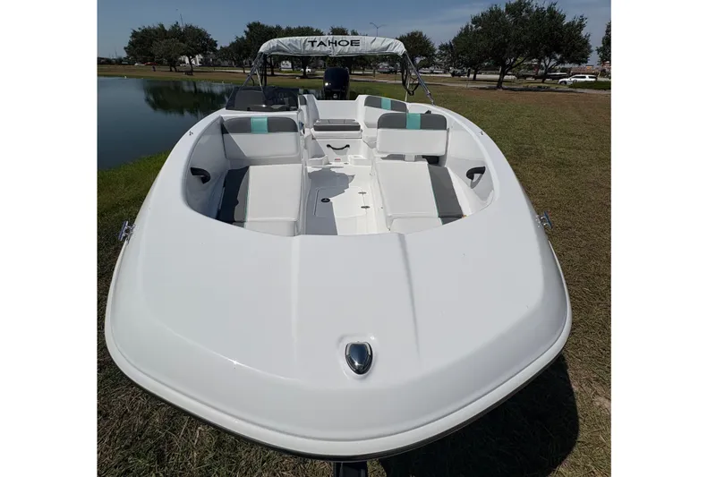 Slide: The Image of 2027 Tahoe T16 boat on grass near a pond under a clear sky. - 9