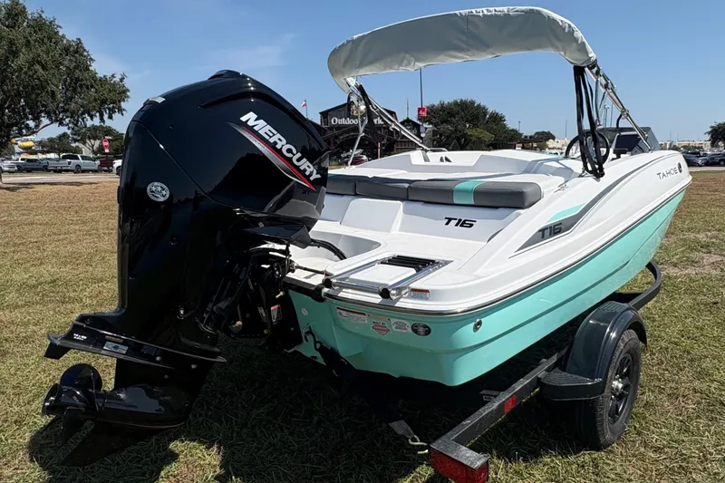 Slide: The Image of 2027 Tahoe T16 boat with Mercury engine on grassy field under clear sky. - 5