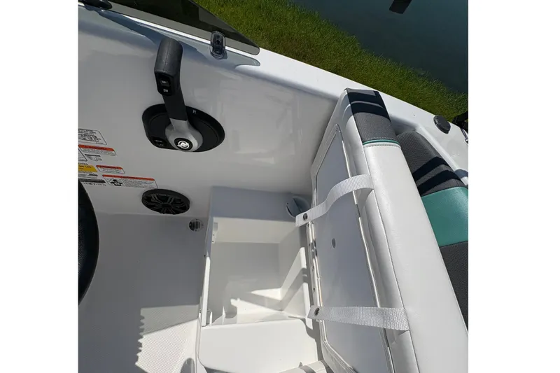 Slide: The Image of 2027 Tahoe T16 boat interior with storage compartment under seat. - 16