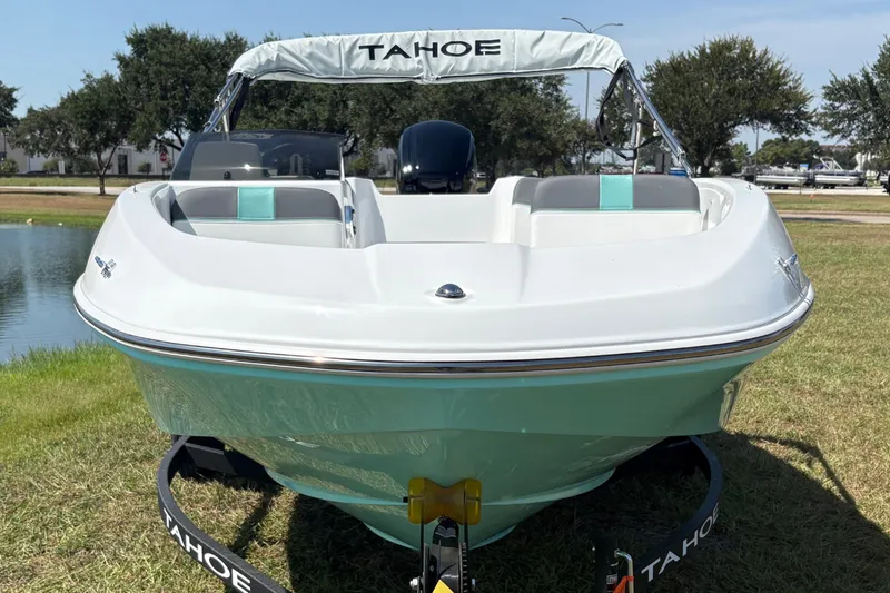 Slide: The Image of 2027 Tahoe T16 boat on trailer by a lake, sunny day, grassy area. - 1