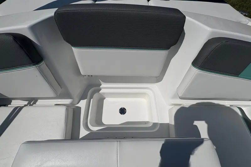 Slide: The Image of 2027 Tahoe T16 boat interior with cushioned seating and storage compartment. - 15