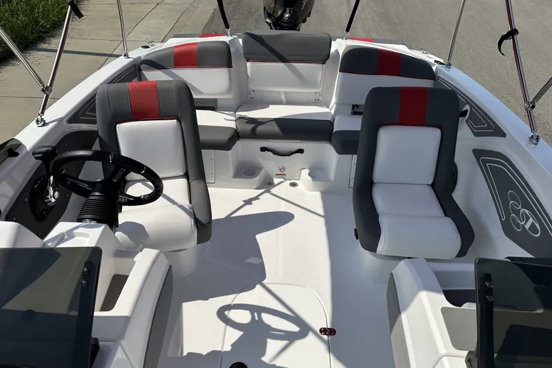 Slide: The Image of 2027 Tahoe T21 boat interior with modern seating and steering wheel design. - 16