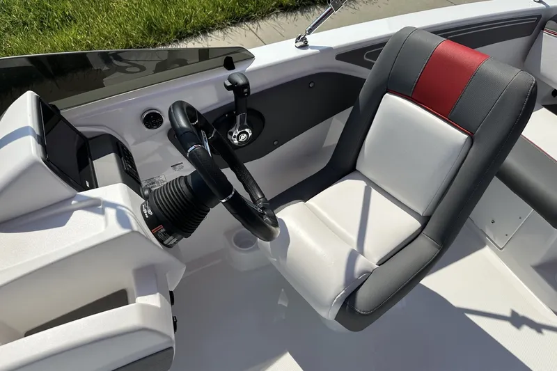 Slide: The Image of Interior of 2027 Tahoe T21 boat with steering wheel and cushioned seat. - 17