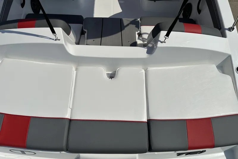 Slide: The Image of 2027 Tahoe T21 boat interior with white, gray, and red cushioned seating. - 24