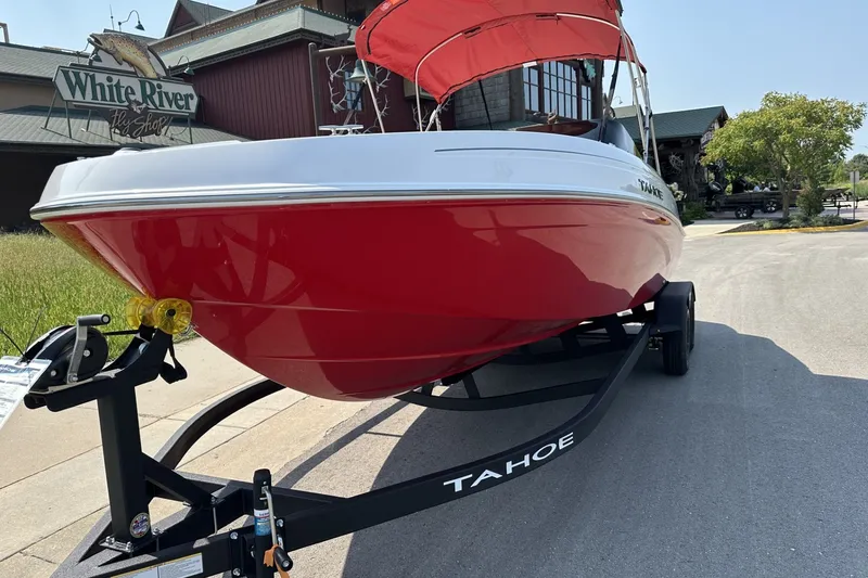 Slide: The Image of 2027 Tahoe T21 boat with red hull on trailer near White River Fly Shop. - 9