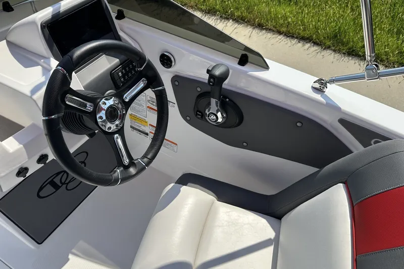 Slide: The Image of Steering wheel and controls of 2027 Tahoe T21 boat interior. - 18